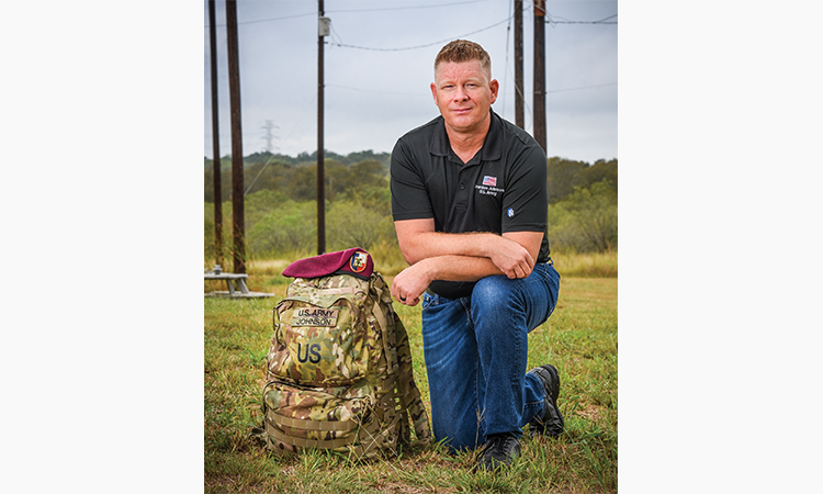 Brandon Johnson with his U.S. Army rucksack and the beret that can be worn with both dress and operational camouflage uniforms. Johnson has worked at Bluebonnet for 15 years and continues to serve the nation as a member of the Army National Guard.