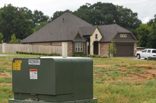 TRANSFORMER: Transformers are mounted on a fiberglass pad and housed in green steel boxes. Inside, voltage is decreased to 240 volts or 120 volts, the level of power used by homes and businesses. Each transformer box can serve up to six secondary junction boxes.