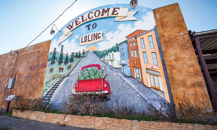 Luling loves to show pride in its famous watermelons, from the fanfare around its annual summer Watermelon Thump to the local favorite fruit in shops and restaurants around town. It makes sense that the “Welcome to Luling” mural at the corner of East Davis Street and South Magnolia Avenue would feature a bright red truck loaded to the brim with, yes, watermelons.