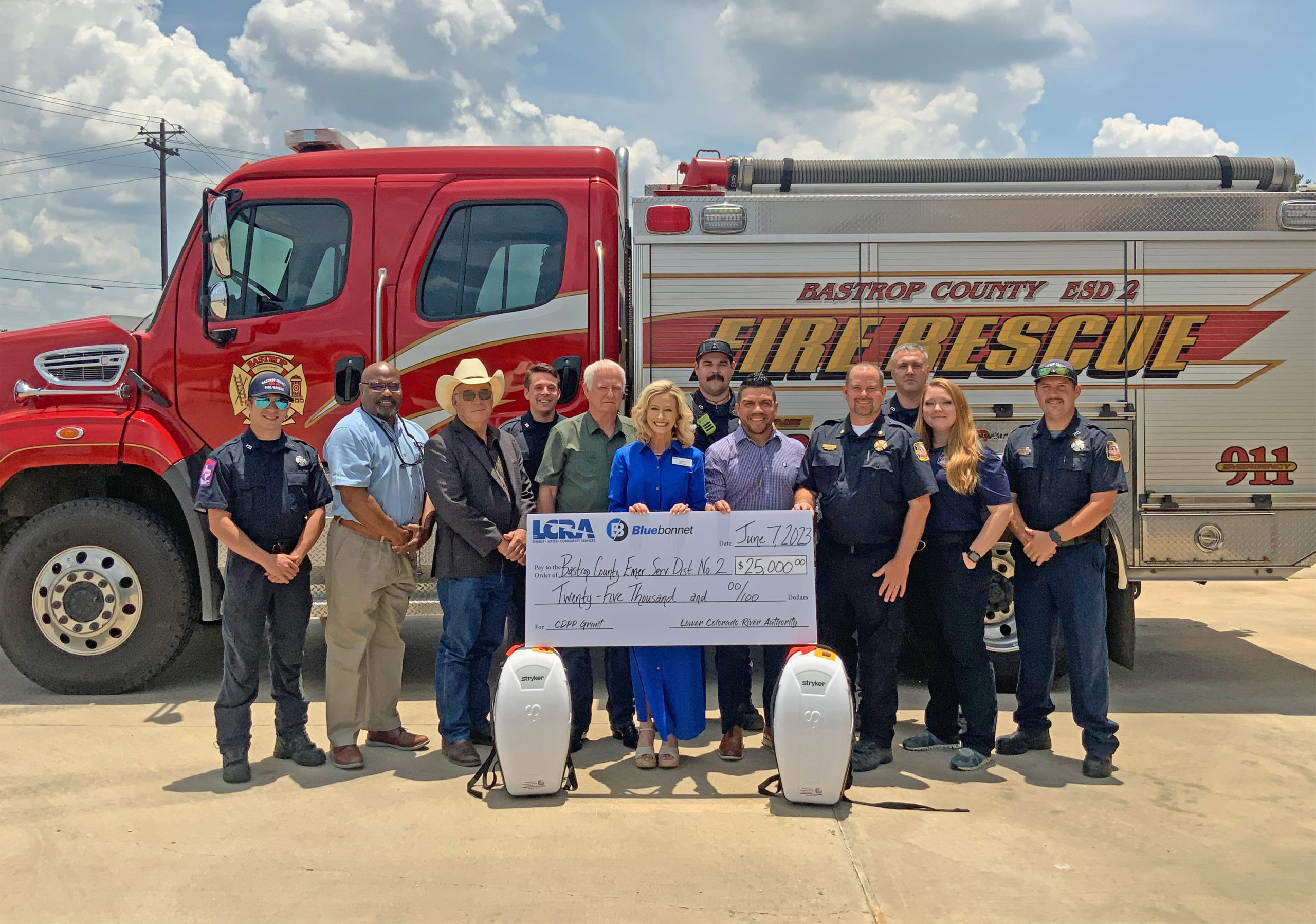 Representatives from LCRA and Bluebonnet Electric Cooperative present a $25,000 grant to Bastrop County first responders for new CPR devices. The grant is part of LCRA’s Community Development Partnership Program. Pictured, from left to right, are: Seth Moss, firefighter; Rick Arnic, LCRA Regional Affairs representative; Gregory Klaus, Bastrop County judge; Bailey Grahn, firefighter; Robert “Bobby” Lewis and Margaret D. “Meg” Voelter, LCRA Board members; Donnie Grauke Jr., firefighter; Josh Coy, Bluebonnet c