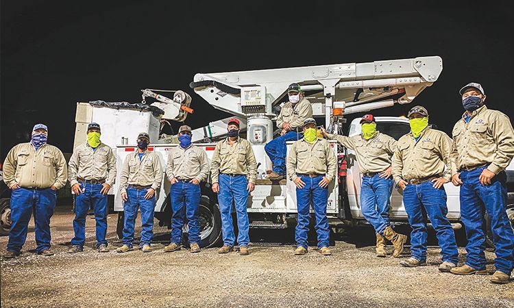 Bluebonnet crews traveled to Deep East Texas Electric Cooperative near the Louisiana border to help restore power to about 25,000 of its members after being hit by Hurricane Laura in late August. Above, from left, just before heading to East Texas, are Daniel Fritsche, Troy Moore, Eric Cobb, Chris Rivera, Michael Guajardo, John Horton, Nick Baker, Heath Walden, Joshua Gonzales and Derek Morgan. Below, from left: Bluebonnet crews use two bucket trucks and a digger truck to make repairs; Troy Moore, left, and