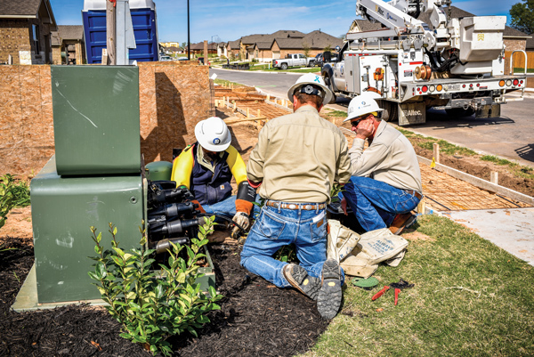 3 employees working on underground transformer