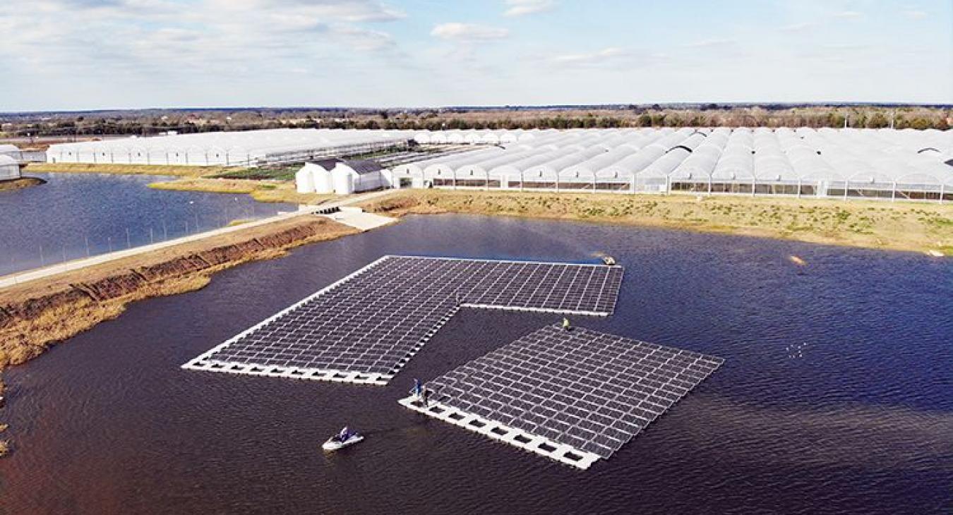 During installation, workers use personal watercrafts to maneuver parts of the array into position. Photo courtesy of Speir Commercial & Industrial