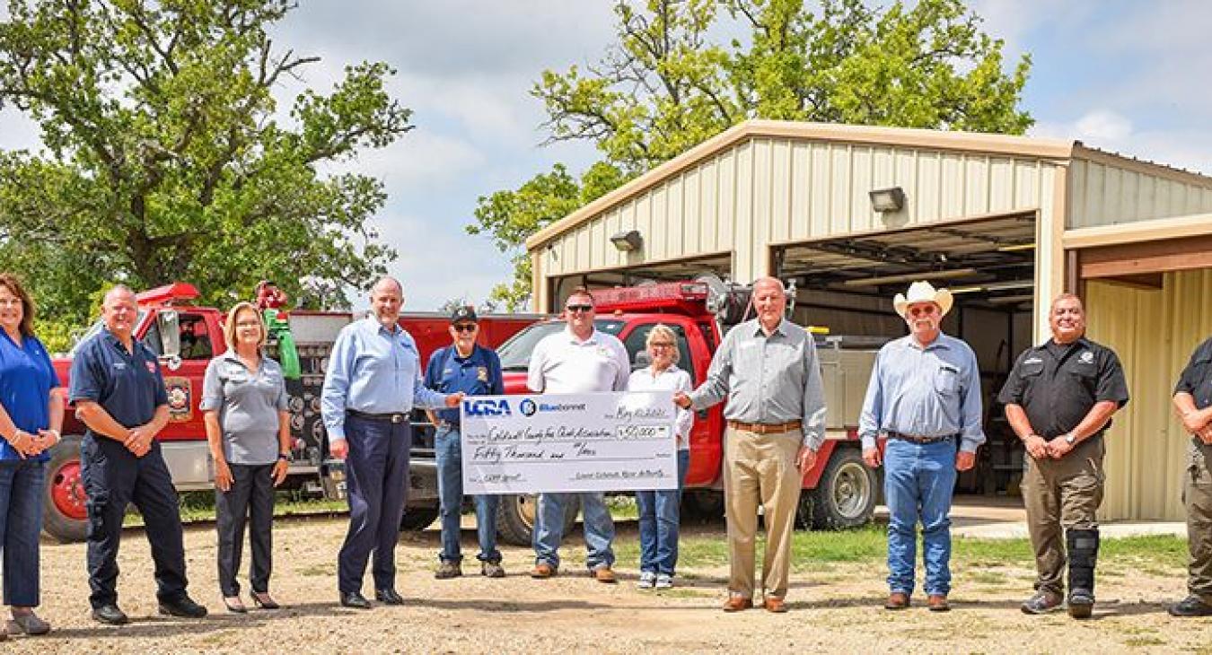 Pictured, from left to right, are: Joyce Buckner, Bluebonnet community representative; Danney Rodgers, CCFCA vice president; Lori A. Berger, LCRA board member; Phil Wilson, LCRA general manager; Jerry Doyle, CCFCA member; Edward Hanna, CCFCA president; Linda Haden, CCFCA fundraising organizer; Milton Shaw, Bluebonnet Board member; Hoppy Haden, Caldwell County judge; Hector Rangel, Caldwell County emergency management coordinator; and Hank Alex, Caldwell County assistant emergency management coordinator.