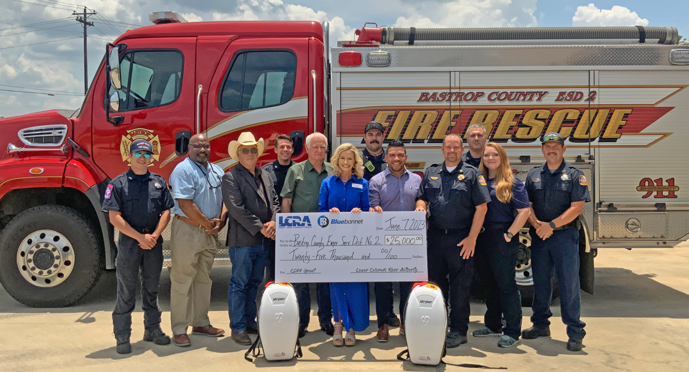 Representatives from LCRA and Bluebonnet Electric Cooperative present a $25,000 grant to Bastrop County first responders for new CPR devices. The grant is part of LCRA’s Community Development Partnership Program. Pictured, from left to right, are: Seth Moss, firefighter; Rick Arnic, LCRA Regional Affairs representative; Gregory Klaus, Bastrop County judge; Bailey Grahn, firefighter; Robert “Bobby” Lewis and Margaret D. “Meg” Voelter, LCRA Board members; Donnie Grauke Jr., firefighter; Josh Coy, Bluebonnet c