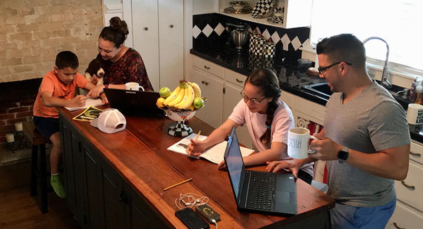 Angela Coy, second from left, a manager in the co-op’s finance department, works from home as does husband, Josh, right. Their children, Joey, 8, left, and Lanie, 11, do schoolwork remotely. Everyone chips in on household chores.