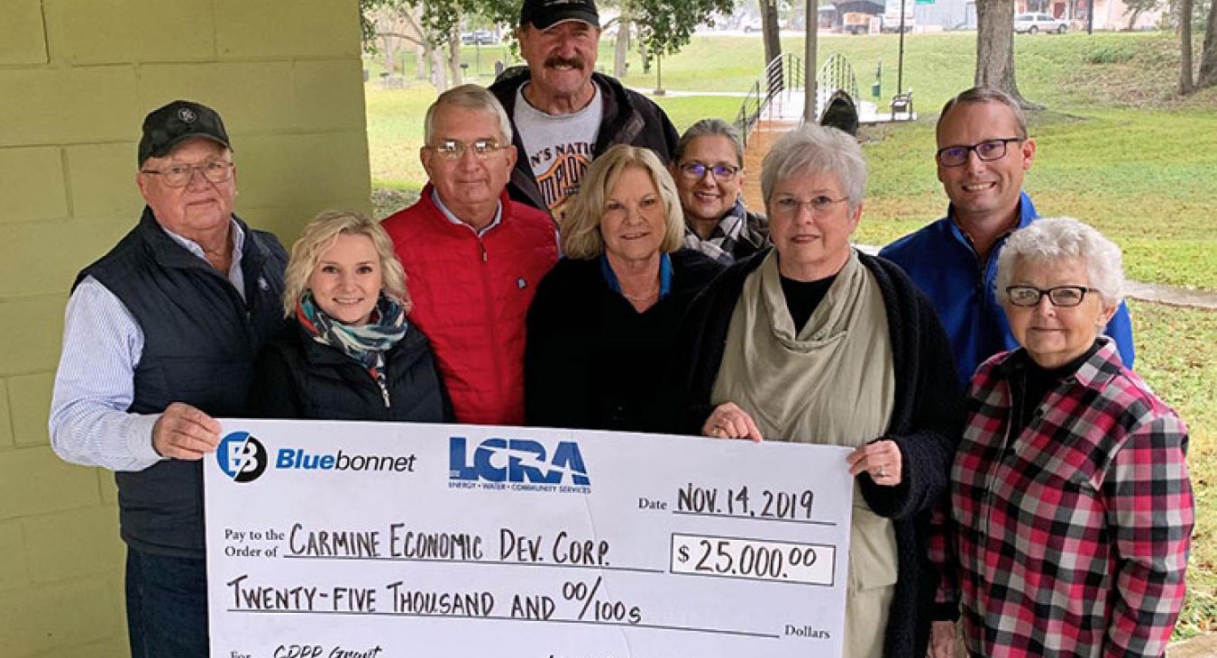 LCRA and Bluebonnet Electric Cooperative representatives present a $25,000 grant to the Carmine Economic Development Corporation for improvements to Muehlbrad-Albers City Park. The grant is part of LCRA’s Community Development Partnership Program