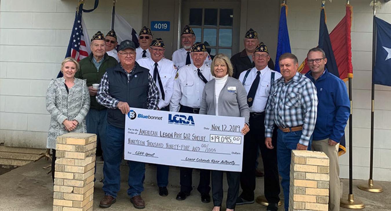 LCRA and Bluebonnet Electric Cooperative representatives present a $19,095 grant to American Legion Post 602 Shelby for building renovations. The grant is part of LCRA’s Community Development Partnership Program