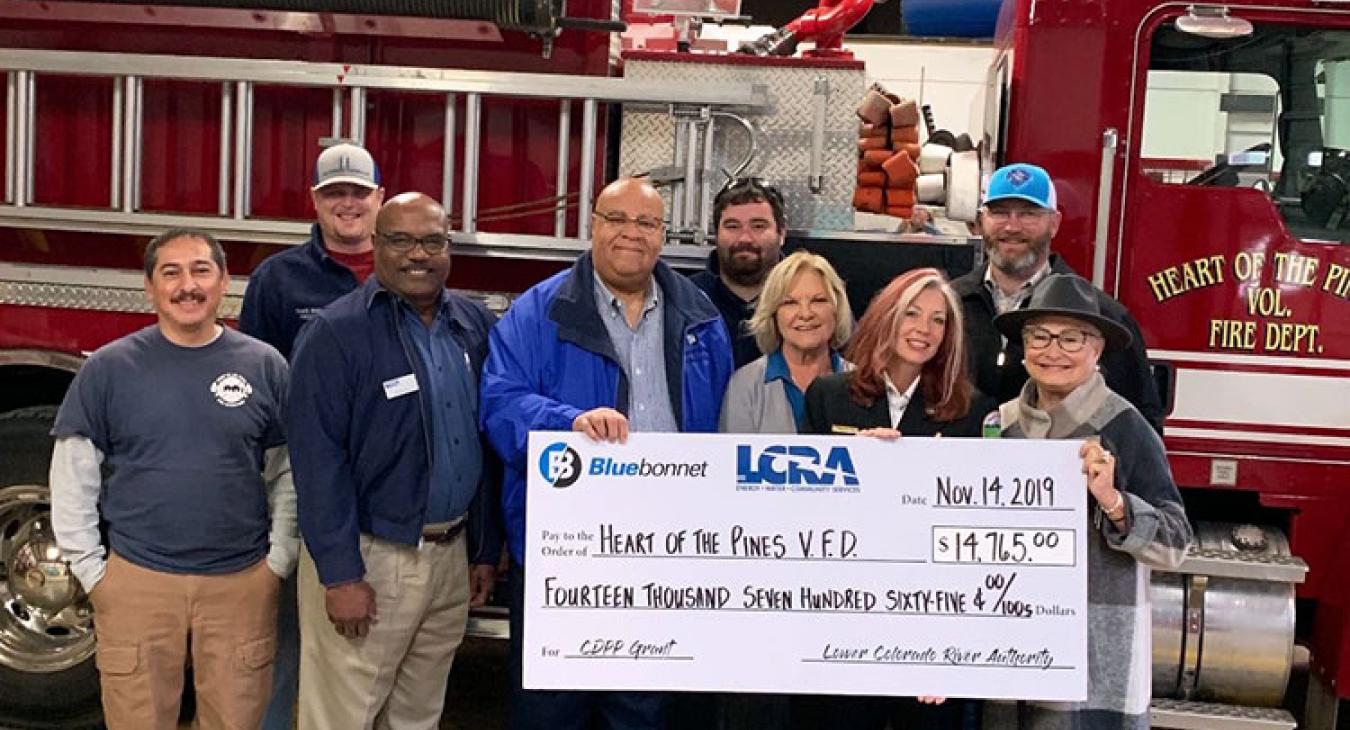 LCRA and Bluebonnet Electric Cooperative representatives present a $14,765 grant to the Heart of the Pines Volunteer Fire Department for an off-road utility vehicle with fire-suppression equipment. The grant is part of LCRA’s Community Development Partnership Program.