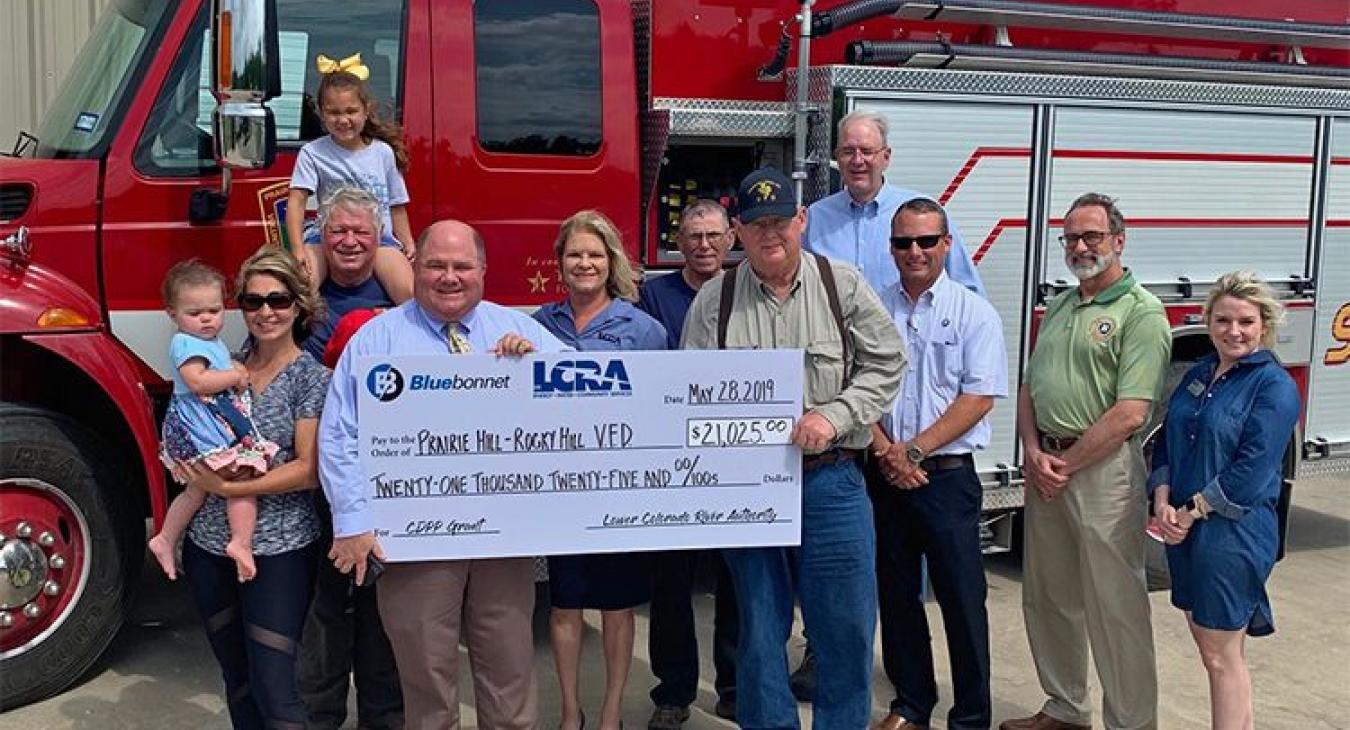 LCRA and Bluebonnet Electric Cooperative representatives present a $21,025 grant to the Prairie Hill-Rocky Hill Volunteer Fire Department for a new all-terrain vehicle and firefighting/rescue equipment.
