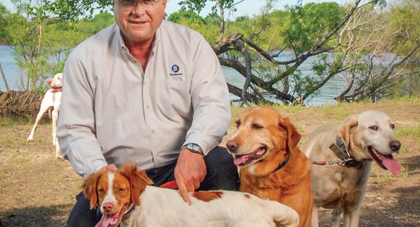 Rick Schmidt was on the Bluebonnet Electric Cooperative Board of Directors for 25 years and was board chairman for 12 years. He was a passionate advocate for co-op members. Schmidt with some of his hunting dogs in a 2006 photo.
