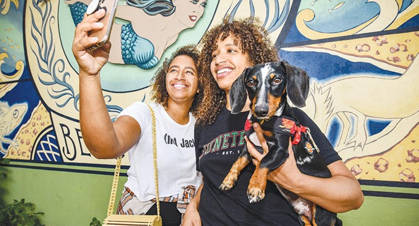  Sisters Christina, left, and Jackie Venson and dog, Jack, stop for a selfie at the ‘Diving into the Divine’ mermaid-themed mural in San Marcos at 202 E. Hopkins St. Jackie might look familiar: She is a popular Austin-based recording artist — a guitarist and singer/songwriter. 