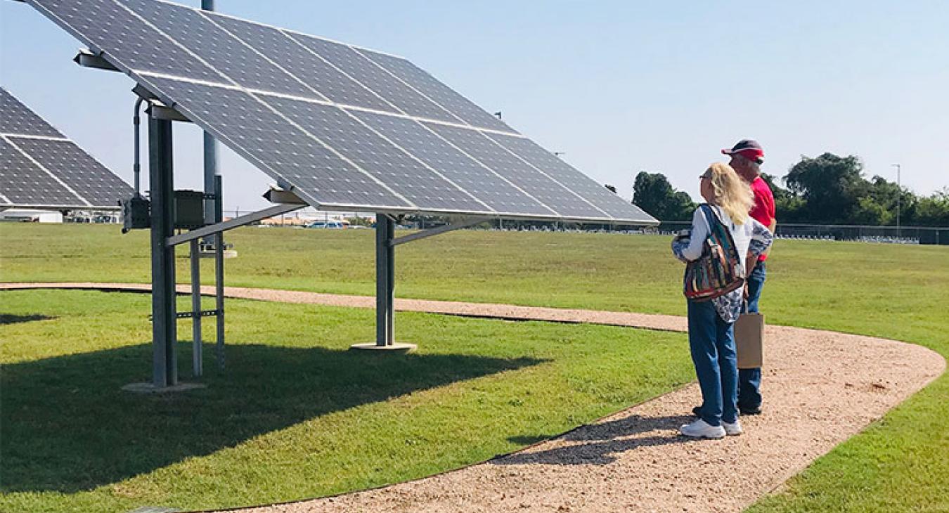 Two participants at Bluebonnet Electric Cooperative's fourth annual Solar Day examine the solar panels that provide power to the Eco Home on the co-op's Brenham campus. (Photo by Joe Stafford)