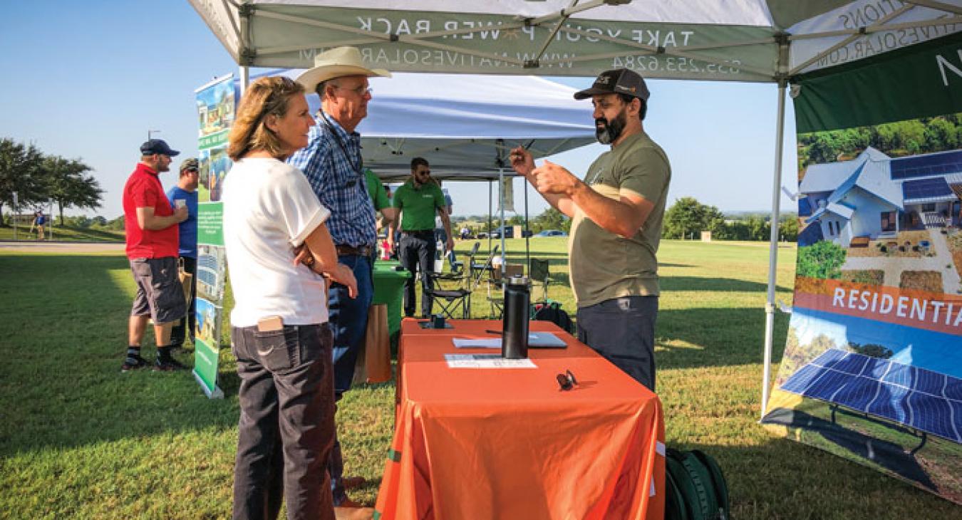 Members talk with David Henry of Native Solar during the installer fair, hosted by Texas Solar Energy Society. (Photo by Sarah Beal)