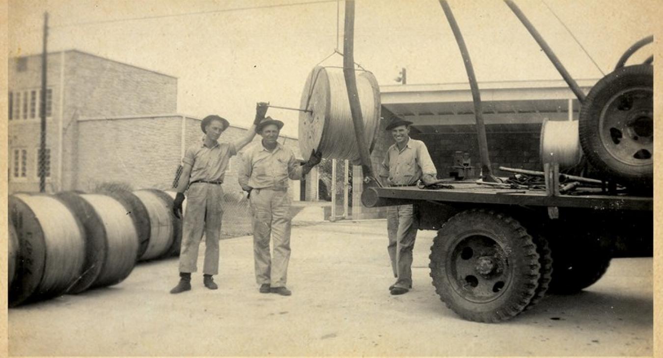 Bluebonnet line workers in the 1940s take a break from their hazardous and backbreaking work in Giddings, original home to the co-op’s headquarters. From left, William Proske, Walter Urban and Winslow Zwerneman.