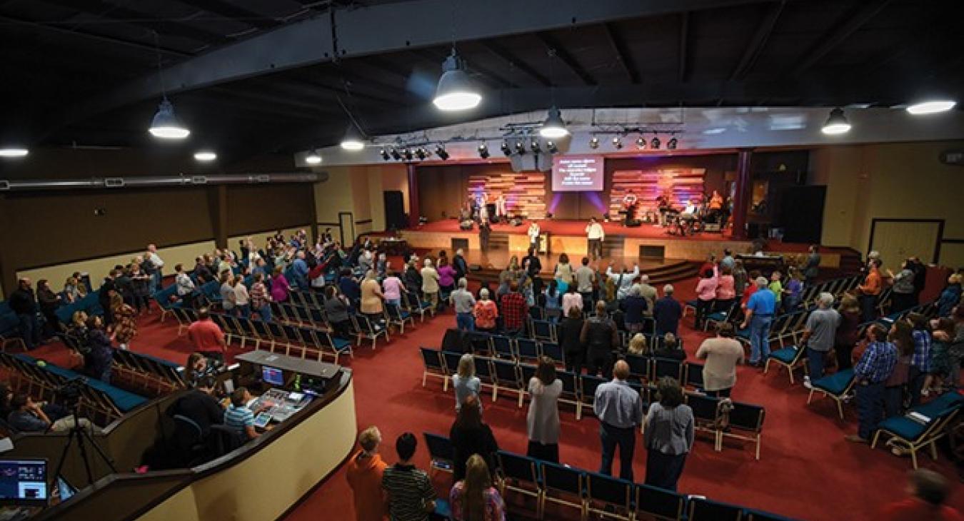 Congregants stand during services on a recent Sunday at the Family Worship Center, located between Bastrop and Elgin. Large open areas such as a church’s sanctuary can use a lot of electricity in a short time, creating energy efficiency challenges. (Sarah Beal photo)