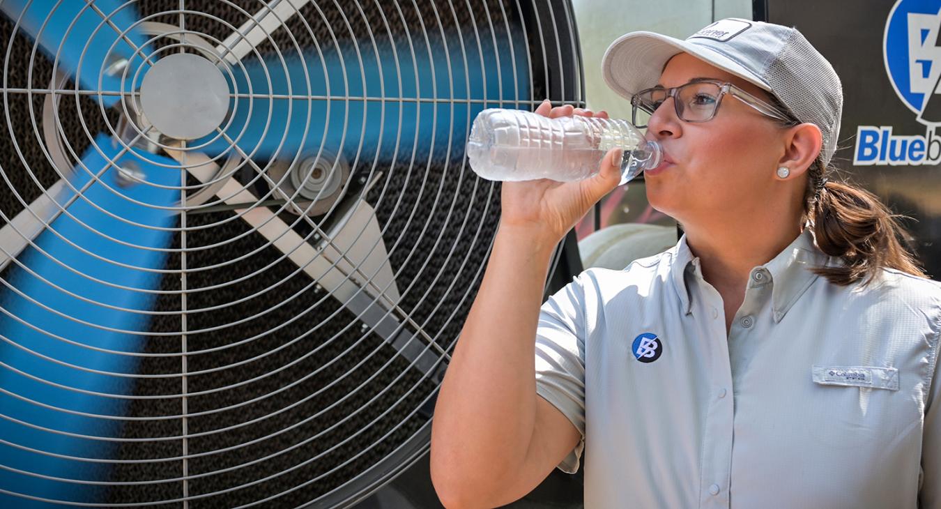 Bluebonnet employee drinking water