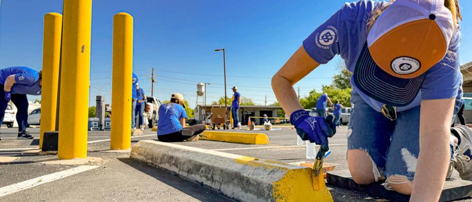 Bluebonnet partners with LCRA for Steps Forward Day 2025. Employees repainted tire stops, an iron fence and speed humps at the Smithville Rec Center.